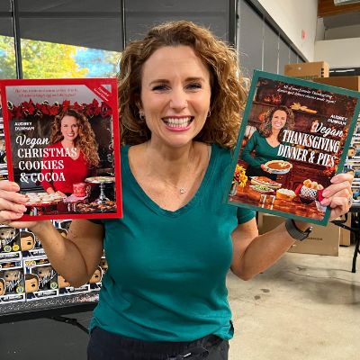 Audrey Dunham showing two of the cookbooks she published.